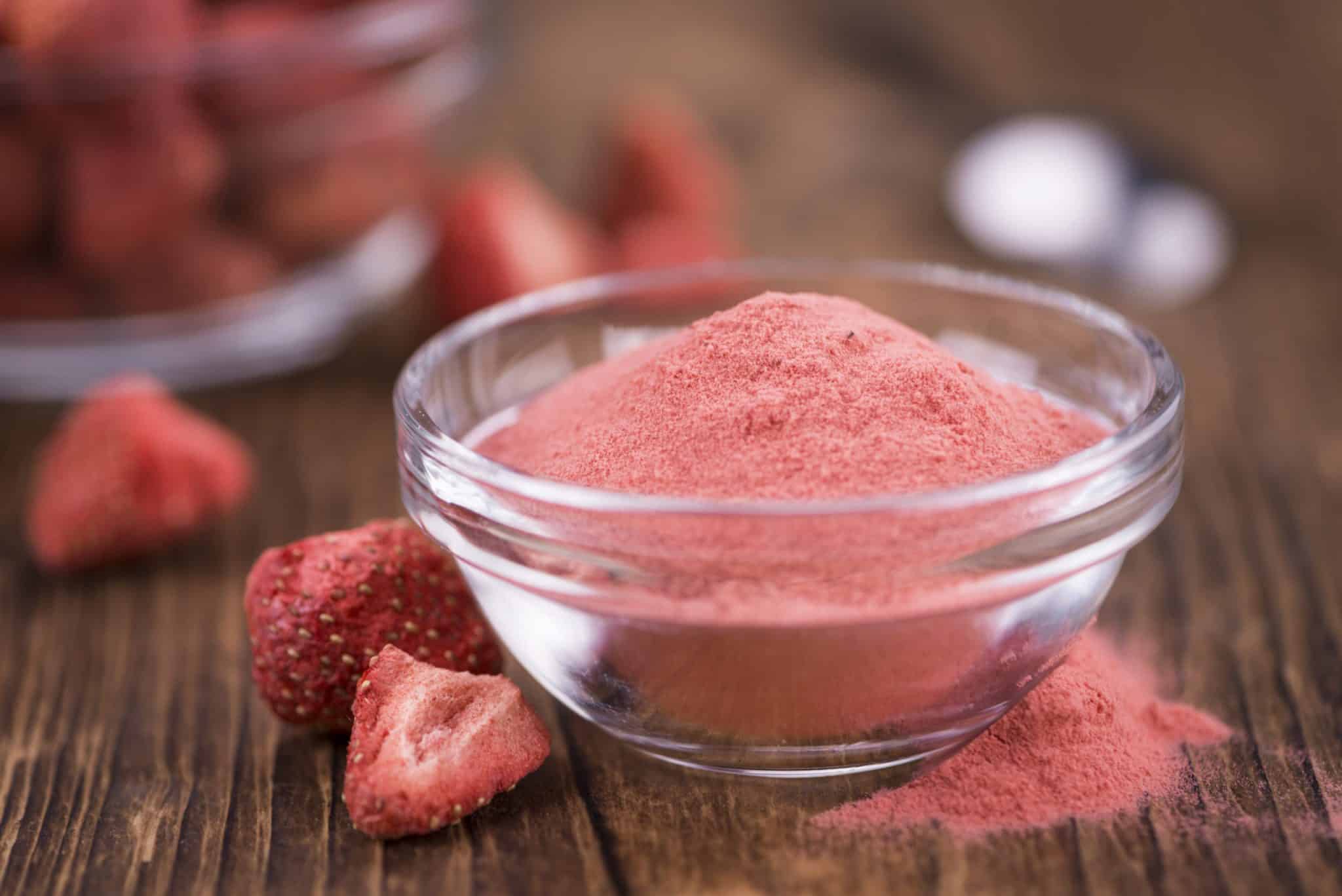 Strawberry powder on wooden background; selective focus